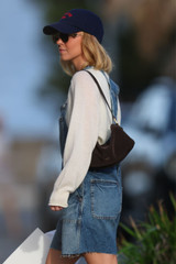 Profile view of model wearing the Oroton Cali Suede Baguette in Dark Chocolate and Premium cow suede leather for Women .