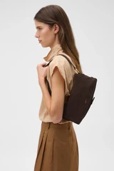 Profile view of model wearing the Oroton Cali Suede Baguette in Dark Chocolate and Premium cow suede leather for Women .