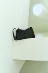 Profile view of model wearing the Oroton Cali Suede Shoulder Bag in Dark Chocolate and Premium cow suede leather for Women .