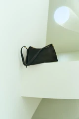 Profile view of model wearing the Oroton Cali Suede Shoulder Bag in Dark Chocolate and Premium cow suede leather for Women .