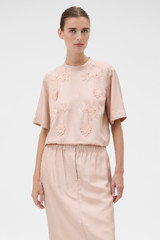 Profile view of model wearing the Oroton Ribbon Trim Top in Rose Tint and 100% silk twill fabric for Women .