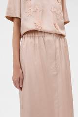 Profile view of model wearing the Oroton Silk Trouser Skirt in Rose Tint and 100% silk twill fabric for Women .