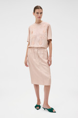 Profile view of model wearing the Oroton Silk Trouser Skirt in Rose Tint and 100% silk twill fabric for Women .