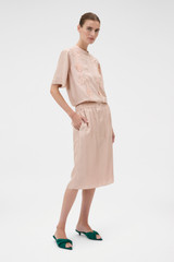 Profile view of model wearing the Oroton Silk Trouser Skirt in Rose Tint and 100% silk twill fabric for Women .