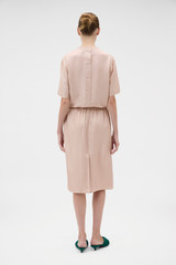 Profile view of model wearing the Oroton Silk Trouser Skirt in Rose Tint and 100% silk twill fabric for Women .