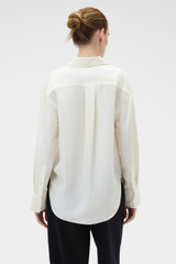 Profile view of model wearing the Oroton Long Sleeve Shirt in Soft Cream and 100% silk habotai fabric for Women .