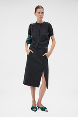 Profile view of model wearing the Oroton Wool Pencil Skirt in Dark Charcoal and 100% birdseye tweed wool suiting fabric for Women .