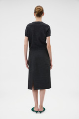 Profile view of model wearing the Oroton Wool Pencil Skirt in Dark Charcoal and 100% birdseye tweed wool suiting fabric for Women .