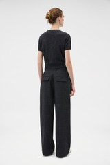 Profile view of model wearing the Oroton Wool Flat Front Pant in Dark Charcoal and 100% wool fabric for Women .
