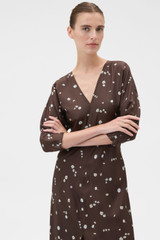 Profile view of model wearing the Oroton Mini Daisy Day Dress in Milk Chocolate and 100% silk twill fabric for Women .