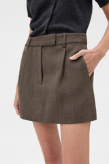Profile view of model wearing the Oroton Herringbone Mini Skirt in Nutmeg and 100% wool fabric for Women .