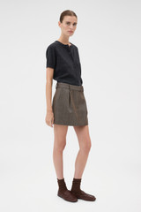 Profile view of model wearing the Oroton Herringbone Mini Skirt in Nutmeg and 100% wool fabric for Women .
