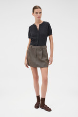 Profile view of model wearing the Oroton Herringbone Mini Skirt in Nutmeg and 100% wool fabric for Women .