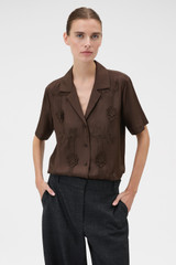Profile view of model wearing the Oroton Ribbon Trim Camp Shirt in Dark Chocolate and 100% silk twill fabric for Women .