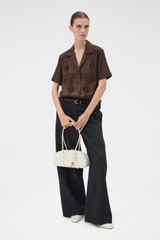Profile view of model wearing the Oroton Ribbon Trim Camp Shirt in Dark Chocolate and 100% silk twill fabric for Women .