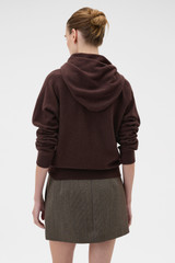 Profile view of model wearing the Oroton Scarf Knit in Dark Chocolate and 100% mid-gauge Merino wool fabric for Women .