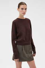 Profile view of model wearing the Oroton Scarf Knit in Dark Chocolate and 100% mid-gauge Merino wool fabric for Women .