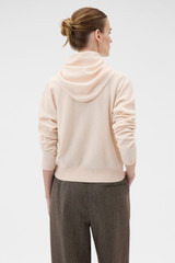 Profile view of model wearing the Oroton Scarf Knit in Rose Tint and 100% mid-gauge Merino wool fabric for Women .