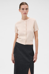 Profile view of model wearing the Oroton Short Sleeve Crew Cardigan in Rose Tint and 100% mid-gauge Merino wool fabric for Women .