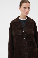 Profile view of model wearing the Oroton Suede Jacket in Dark Chocolate and 100% suede leather for Women .