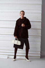 Profile view of model wearing the Oroton Suede Jacket in Dark Chocolate and 100% suede leather for Women .