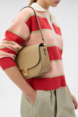 Profile view of model wearing the Oroton Yvonne Medium Day Bag in Mushroom and Premium pebble leather for Women .