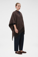 Profile view of model wearing the Oroton Harvey Signature Reversible Poncho in Umber/Burnt Umber and 50% acrylic and 50% wool blend fabric for Women .
