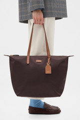 Profile view of model wearing the Oroton Lilly Nylon Light Weight Tote Bag in Burnt Umber/Cognac and Nylon fabric material for Women .