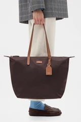 Profile view of model wearing the Oroton Lilly Nylon Light Weight Tote Bag in Burnt Umber/Cognac and Nylon fabric material for Women .
