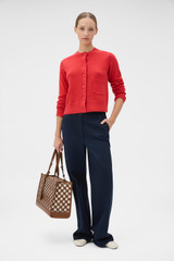Profile view of model wearing the Oroton Knit Detail Cardigan in Soft Red and 100% superfine wool fabric for Women .