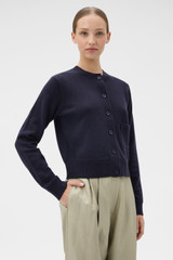 Profile view of model wearing the Oroton Knit Detail Cardigan in North Sea and 100% superfine wool fabric for Women .