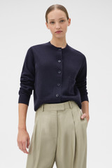 Profile view of model wearing the Oroton Knit Detail Cardigan in North Sea and 100% superfine wool fabric for Women .
