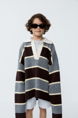 Profile view of model wearing the Oroton Rugby Stripe Knit in Dark Chocolate and 100% superfine wool fabric for Women .