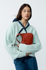 Profile view of model wearing the Oroton Rib Knit Popover in Mint and 100% superfine wool fabric for Women .