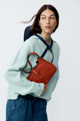 Profile view of model wearing the Oroton Rib Knit Popover in Mint and 100% superfine wool fabric for Women .