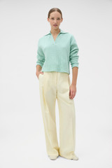Profile view of model wearing the Oroton Rib Knit Popover in Mint and 100% superfine wool fabric for Women .