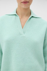 Profile view of model wearing the Oroton Rib Knit Popover in Mint and 100% superfine wool fabric for Women .