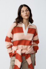Profile view of model wearing the Oroton Rugby Stripe Knit in Soft Red and 100% superfine wool fabric for Women .