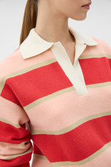 Profile view of model wearing the Oroton Rugby Stripe Knit in Soft Red and 100% superfine wool fabric for Women .