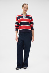 Profile view of model wearing the Oroton Rugby Stripe Knit in North Sea and 100% superfine wool fabric for Women .
