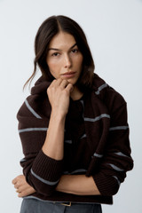 Profile view of model wearing the Oroton Stripe Knit Pullover in Dark Chocolate and 100% superfine wool fabric for Women .