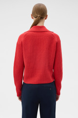 Profile view of model wearing the Oroton Rib Knit Popover in Soft Red and 100% superfine wool fabric for Women .