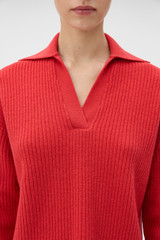 Profile view of model wearing the Oroton Rib Knit Popover in Soft Red and 100% superfine wool fabric for Women .