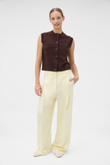 Profile view of model wearing the Oroton Knit Detail Vest in Dark Chocolate and 100% superfine wool fabric for Women .