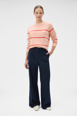 Profile view of model wearing the Oroton Stripe Knit Pullover in Peach and 100% superfine wool fabric for Women .