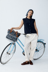 Profile view of model wearing the Oroton Knit Detail Vest in North Sea and 100% superfine wool fabric for Women .