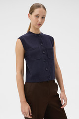 Profile view of model wearing the Oroton Knit Detail Vest in North Sea and 100% superfine wool fabric for Women .