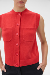 Profile view of model wearing the Oroton Knit Detail Vest in Soft Red and 100% superfine wool fabric for Women .