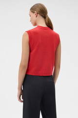 Profile view of model wearing the Oroton Knit Detail Vest in Soft Red and 100% superfine wool fabric for Women .