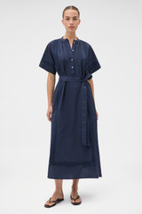 Profile view of model wearing the Oroton Trim Detail Dress in North Sea and 100% cotton fabric for Women .